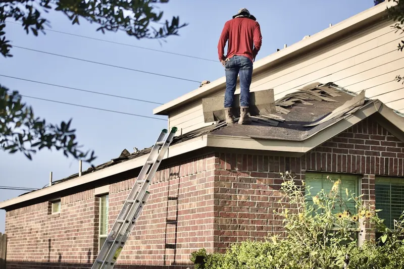Professional roofer working on a residential roof in Winton Hills